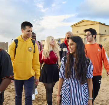 Students walking on the beach