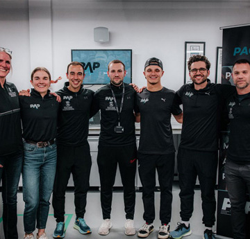 Formula 1 driver Lando Norris with staff from A-STEM